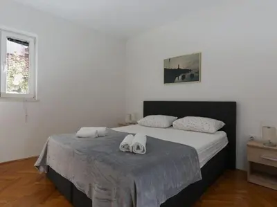 Krevet ili kreveti u jedinici u objektu Apartment Perina - Comfort Two Bedroom Apartment with Terrace and Sea View