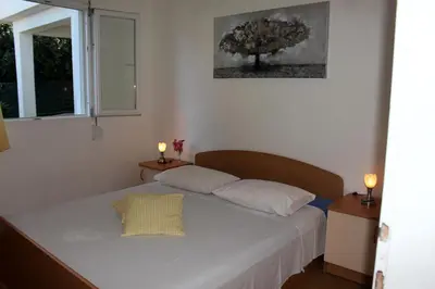 Krevet ili kreveti u jedinici u objektu Apartments by the sea Mimice, Omis - 2774