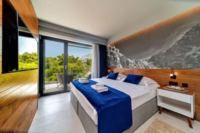 Krevet ili kreveti u jedinici u objektu Luxury Villa Delight II Promajna with pool, gym, sauna and jacuzzi