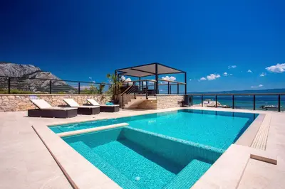 Bazen u objektu Beachfront Villa Draga with 32sqm private, heated pool, 4 bedrooms, sea view ili u blizini